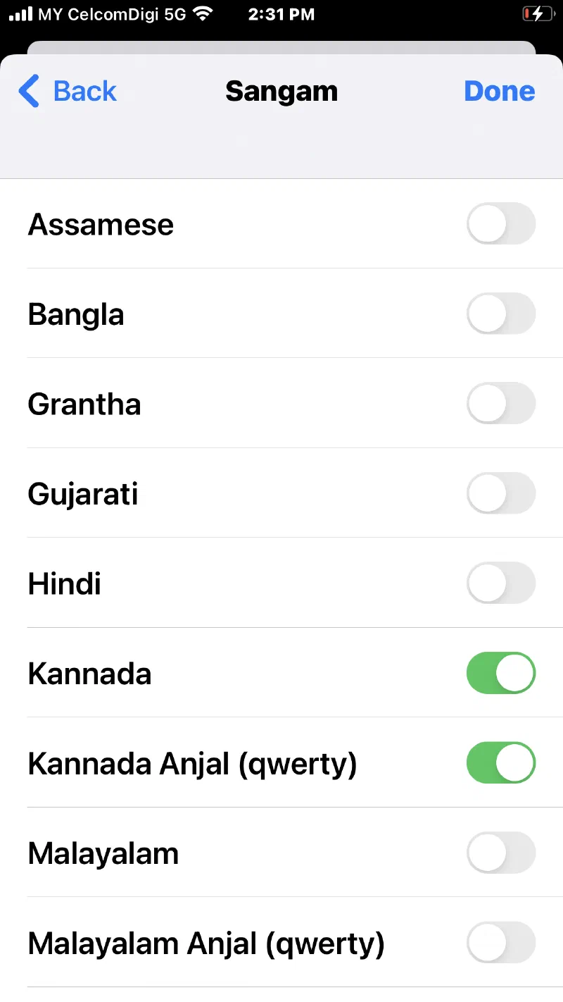 The iOS Settings keyboard list showing the Sangam keyboards — Assamese, Bangla, Grantha, Gujarati, Hindi, Kannada, Malayalam and their Anjal qwerty variants — each with a switch.